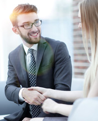 close-up of a manager shakes hands with a regular customer.