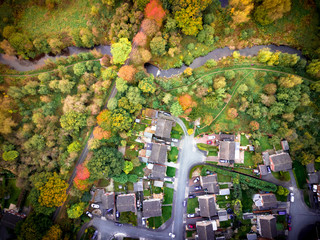 Satellite image style aerial view of country homes rural England. Looking straight down on trees and houses with social and environmental concepts