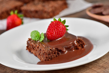Brownie with chocolate sauce and strawberry
