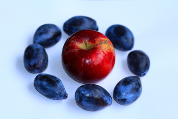 Apple in a circle of plums - fruit