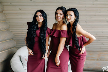 three beautiful bridesmaids in marsala dresses