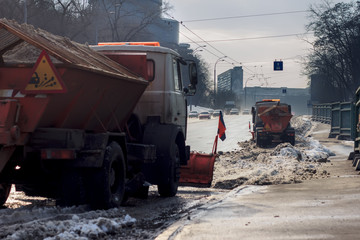 Fototapeta na wymiar Snowplow removing snow from city road