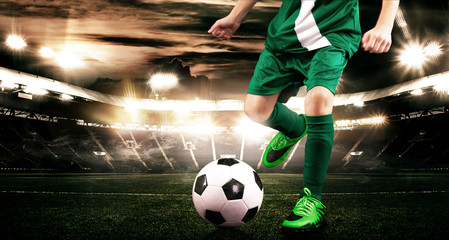 Fototapeta premium Kid - soccer player. Boy forward in football sportswear on stadium with ball. Sport concept.