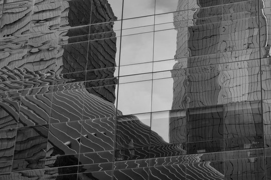 Reflections in glass of lower manhatan in black and white
