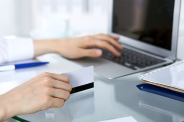 Close up of business woman hands typing on laptop computer