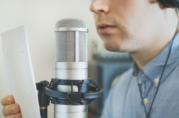 Man recording an advertisement on the radio station.