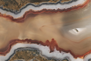 Texture of a large polished agate stone of chalcedony close-up in section cut