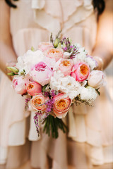 Bridal morning details. Wedding bouquet in the hands of the bride, selectoin focus