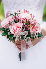 Bridal morning details. Wedding bouquet in the hands of the bride, selectoin focus