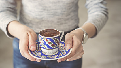 Woman serving a cup of Turkish coffee