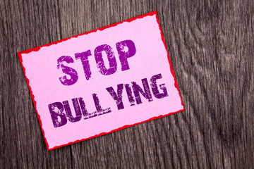 Handwriting Announcement text showing Stop Bullying. Conceptual photo Awareness Problem About Violence Abuse Bully Problem written on Pink Sticky Note Paper on the wooden background.