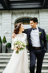 the bride and groom walking down the stairs