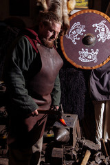 Fototapeta na wymiar Viking sword handles sword rack reenactment forge smith warrior weapon outfit ax shield skin fire hearth one man