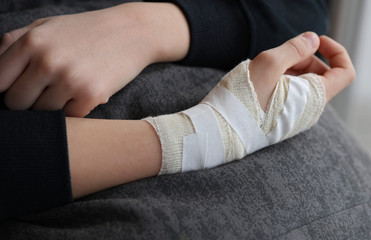 Fototapeta premium Child hand with gauze bandage on it.