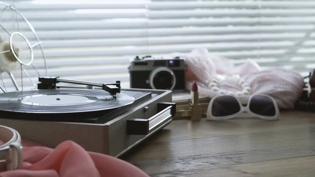 Vintage record player and woman's accessories