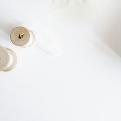 White background with silk ribbon on wooden spool