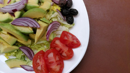 Fresh salad with avocado, asparagus and black olives
