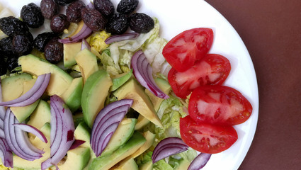Fresh salad with avocado, asparagus and black olives