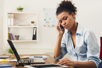 Concentrated business woman talking on phone