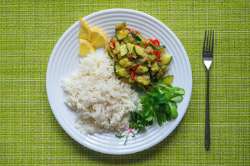 White rice and zucchini with vegetables. Vegetarian cuisine.