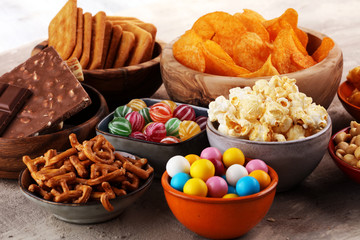 Salty snacks. Pretzels, chips, crackers in wooden bowls.
