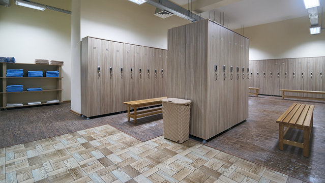Locker room with wood benches and wooden lockers in the gym