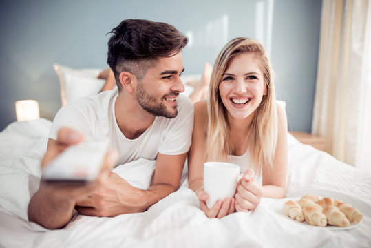 Happy Man And Woman Having Breakfast In Bed