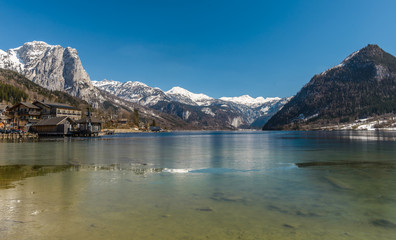 Naklejka na ściany i meble Sunny winter Alpine lake Grundlsee (Styria, Austria) with fantastic reflection on the water surface.