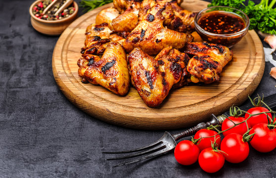 Grilled or oven roasted chicken wings glazed with barbecue sauce