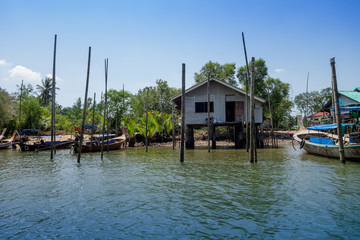 Outdoor view of old and damaged house floating in the river close to the mangroves in a gorgeopus blue asky in Krabi Province, South of Thailand