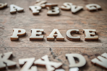 concept wooden letters on wooden table background - Peace