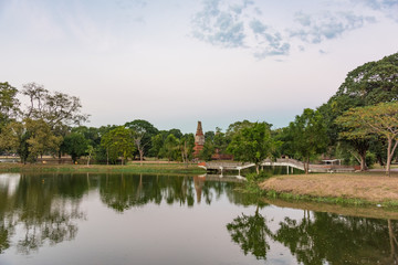 Fototapeta na wymiar City park in Ayutthaya with river and arch bridge