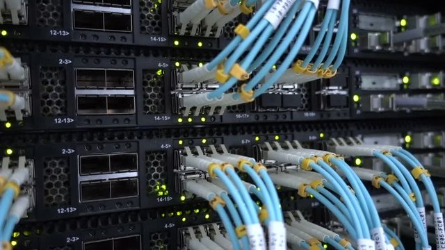 working data servers with flashing LED lights. Lights and connections on network server. Optical server close up