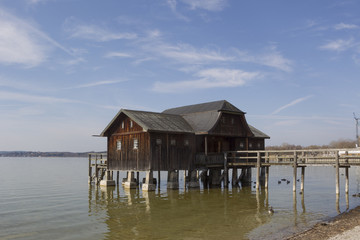 old wooden boathouse with footbridge