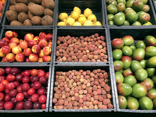 Many different fruits, coconut, nectarines, plums, mango and lychee