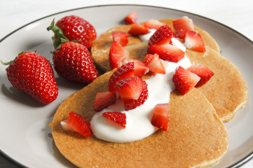 Healthy oat and banana pancake with yoghurt and strawberry 