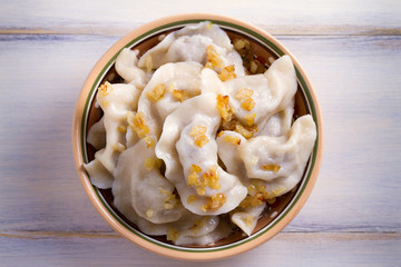 Plate of pierogi or varenyky, vareniki, Dumplings, filled with beef meat and served with fried onion. Pyrohy - dumplings with filling. View from above, top, overhead