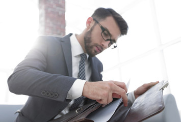 Detail of a businessman holding his briefcase