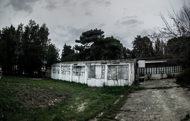 Abandoned village house building in Baku Botanical garden. Nobody in the park with trees. Springtime