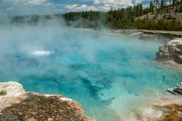 Clear, steaming aquamarine water in Yellowstone hot spring, Wyoming