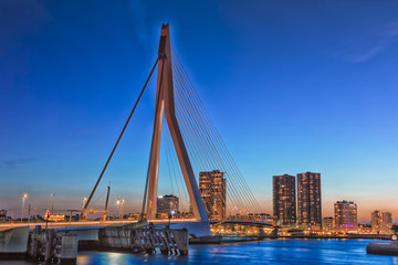 Fototapeta na wymiar Travel Concepts and Ideas. Beautiful and Astonishing View of Rotterdam Skyline with Erasmus Bridge on Foregorund During Blue Hour.