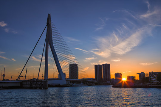 Travel Concepts, Ideas and Destinations.Picturesque View of Erasmus Bridge in Rotterdan Before the Sunset. City Scyline with Lights Off.