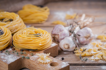 Raw homemade pasta with flour, garlic and spices
