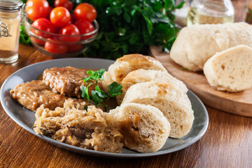 Pork loin in gravy with bread dumplings and sauerkraut