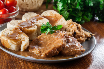 Pork loin in gravy with bread dumplings and sauerkraut