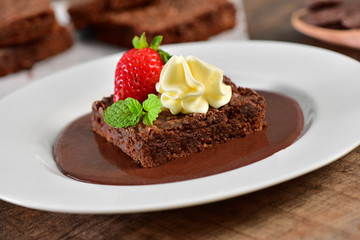 Brownie with chocolate sauce and strawberry