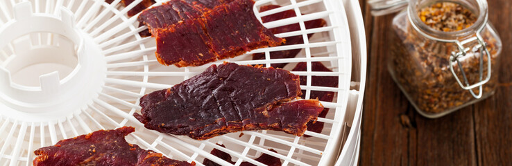 Homemade Beef Jerky with a dehydrator. Selective focus.