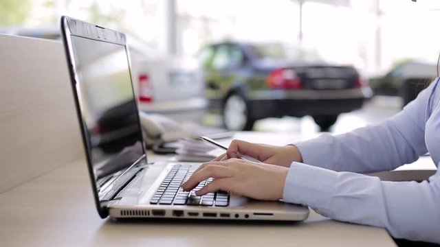Business Person Working On Laptop As Car Dealer