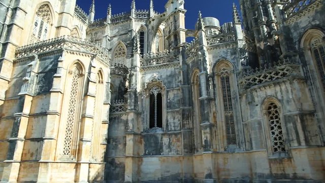 Gothic and Manueline architecture of medieval Batalha Monaster with blue sky. Dominican convent of Saint Mary of the Victory popular landmark and Unesco Heritage in Batalha city, central Portugal.