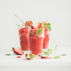 Healthy low calorie summer treat. Strawberry and champaigne granita, slushie or shaved ice dessert in glasses, white background, copy space, square crop. Clean eating, vegan, dieting food concept